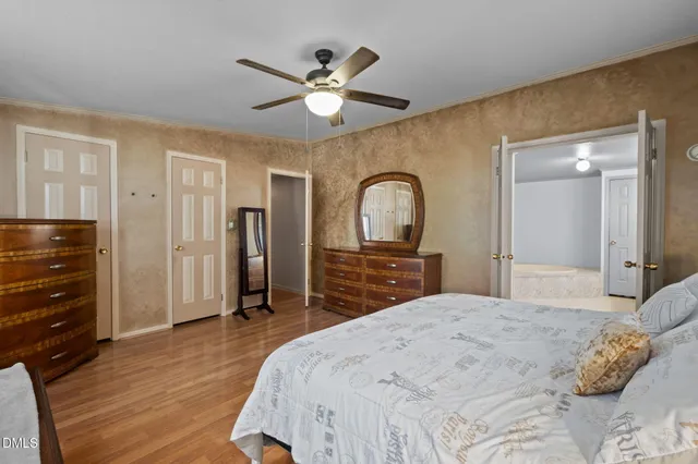 a bedroom with a large bed and a chandelier