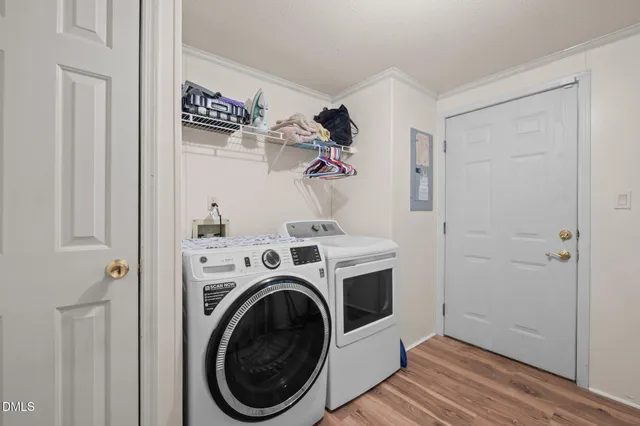 a view of a storage and utility room with washer and dryer