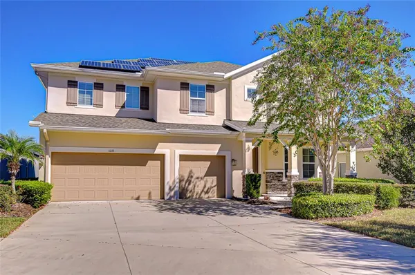 a front view of a house with a yard and garage
