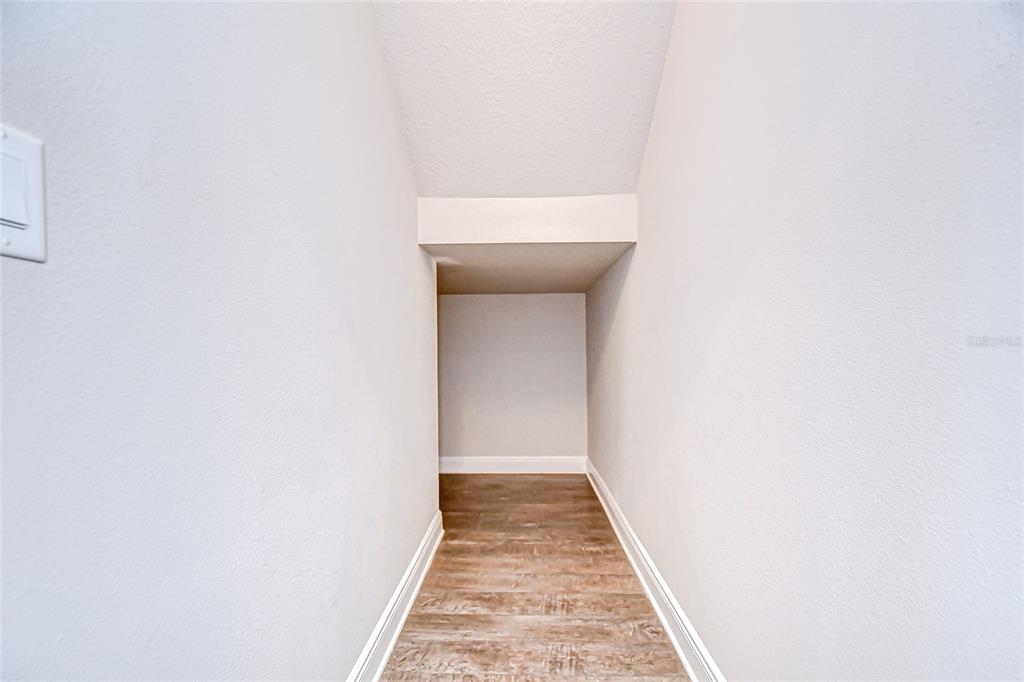 1018 Tracey Ann Loop Valrico, FL 33594 - Photo 31 of 45 a view of a hallway with wooden floor