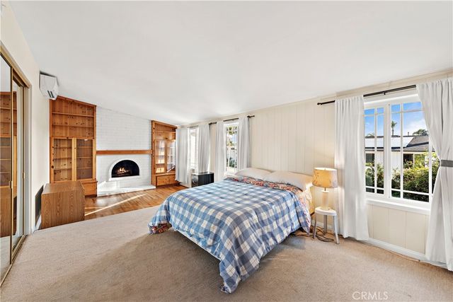 a bedroom with a bed and a fireplace