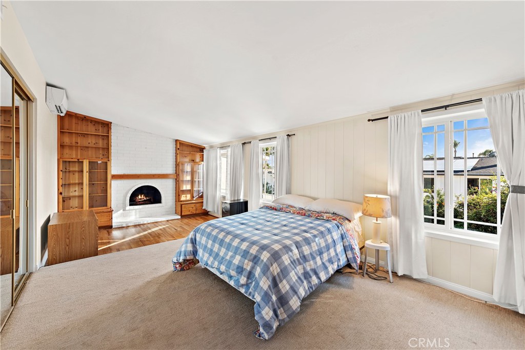 24372 Barbados Drive Dana Point, CA 92629 - Photo 15 of 39 a bedroom with a bed and a fireplace