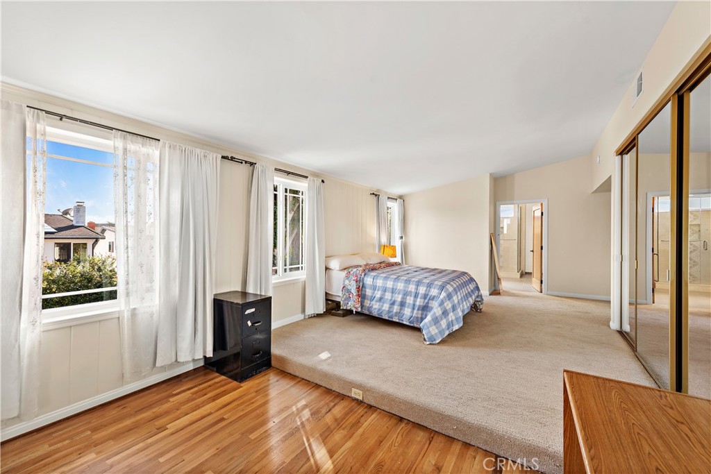 24372 Barbados Drive Dana Point, CA 92629 - Photo 17 of 39 a bedroom with a bed and wooden floor