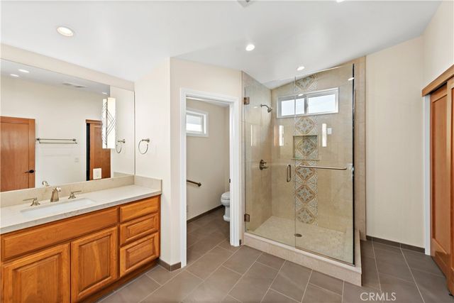 a spacious bathroom with a shower sink and mirror