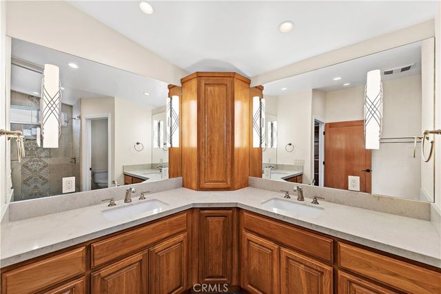 a bathroom with double vanity sinks and a large mirror