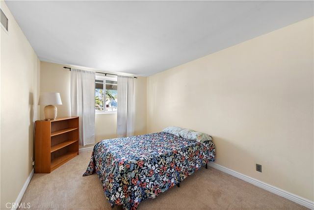 a bedroom with a bed and dresser