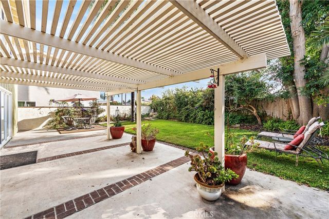 a view of a patio with a table chairs and a backyard