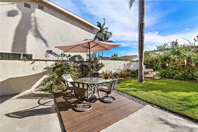 a view of a backyard with sitting area
