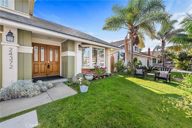 a view of a house with backyard porch and sitting area