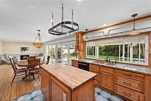 a kitchen with stainless steel appliances granite countertop counter space a sink and living room view