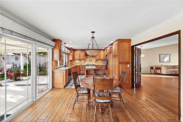 a view of a dining room with furniture wooden floor and a chandelier