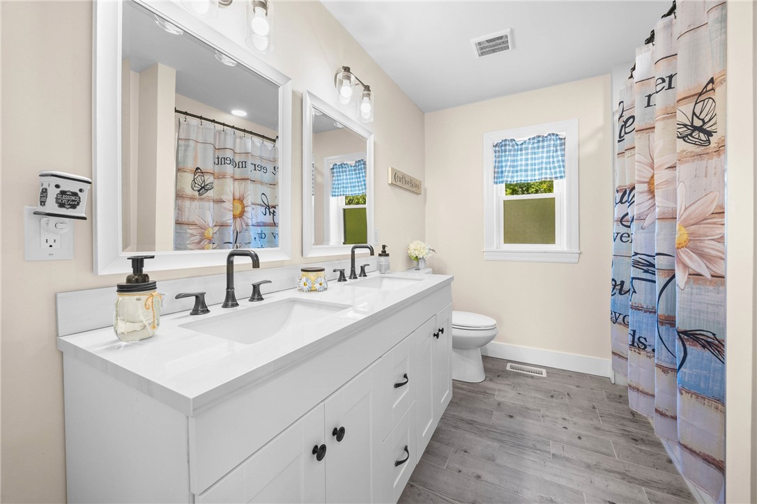 4581 Holley Byron Road Holley, NY 14470 - Photo 28 of 50 Second floor full bath with double sinks and tile tub surround