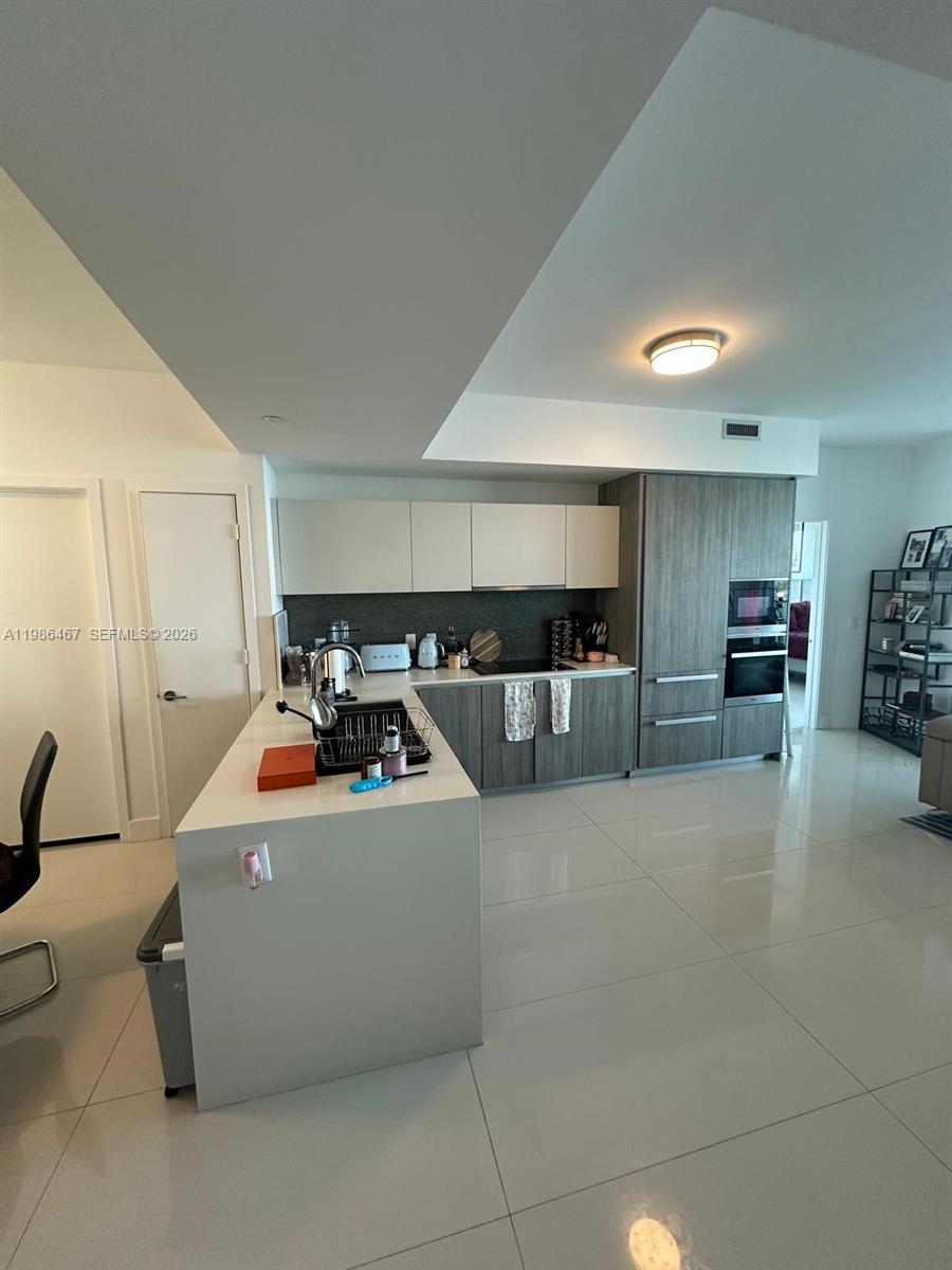 2900 Northeast 7th Avenue, Unit 1003 Miami, FL 33137 - Photo 3 of 15 a view of kitchen with furniture and refrigerator