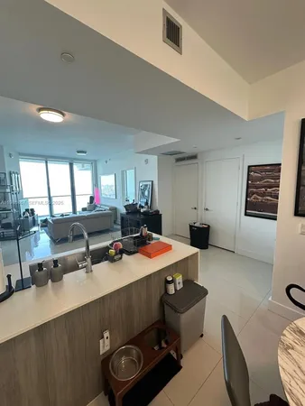 a room with furniture pool table and window