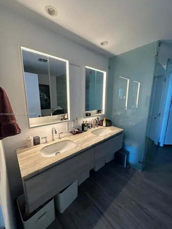 a bathroom with a double vanity sink and a mirror