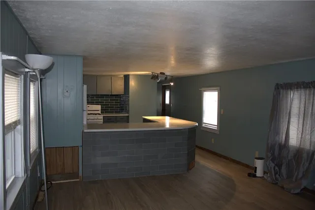 a kitchen with stainless steel appliances granite countertop a refrigerator a sink and a stove