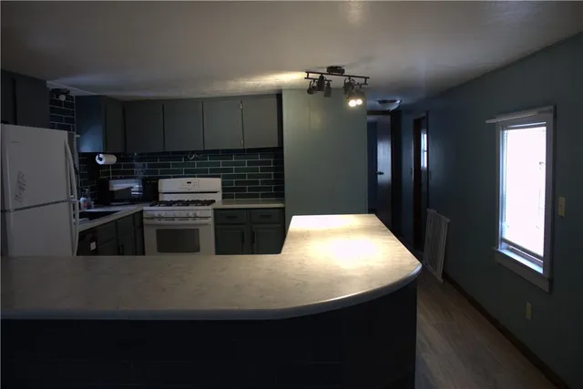 a kitchen with stainless steel appliances a refrigerator sink and stove