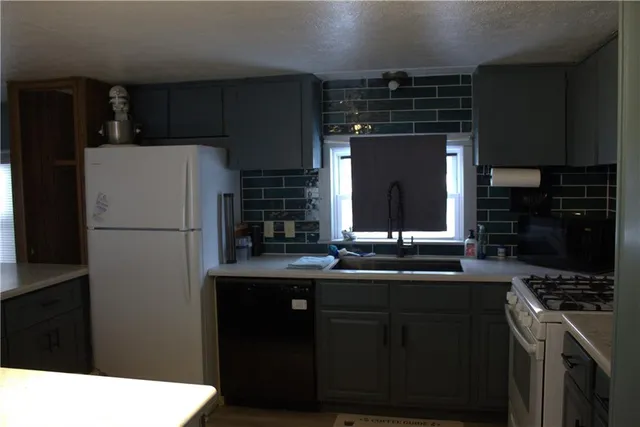 a kitchen with a sink and refrigerator