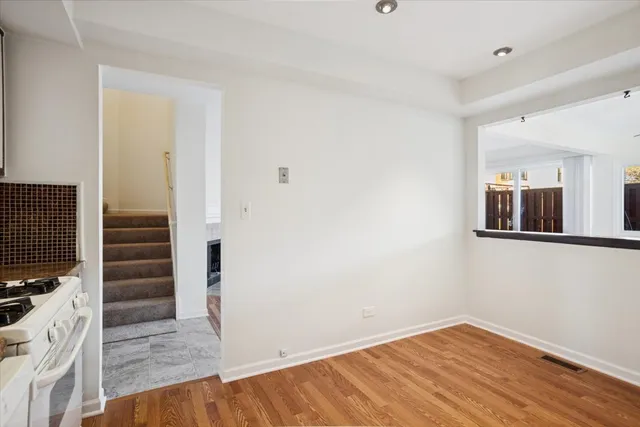 a view of wooden floor and windows in a room