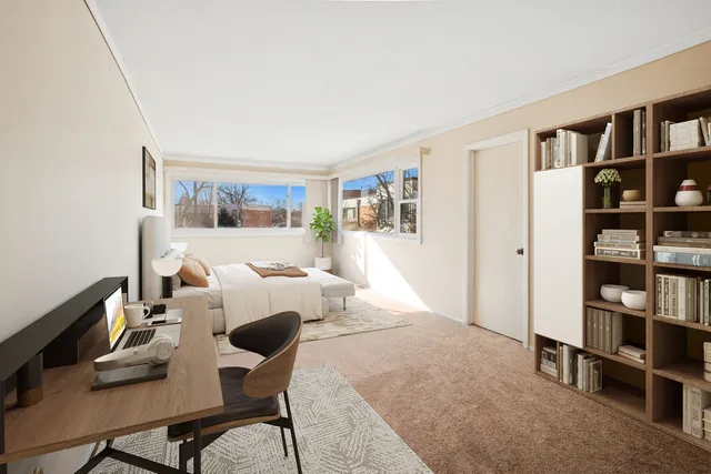 a living room with furniture and a book shelf