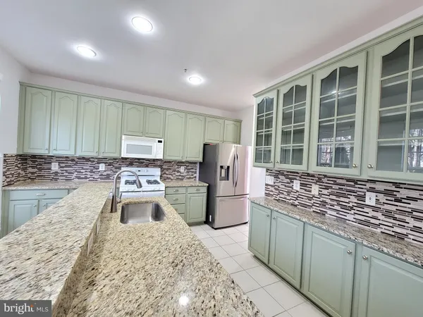 a kitchen with refrigerator and window