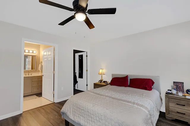 a bedroom with a bed and wooden floor