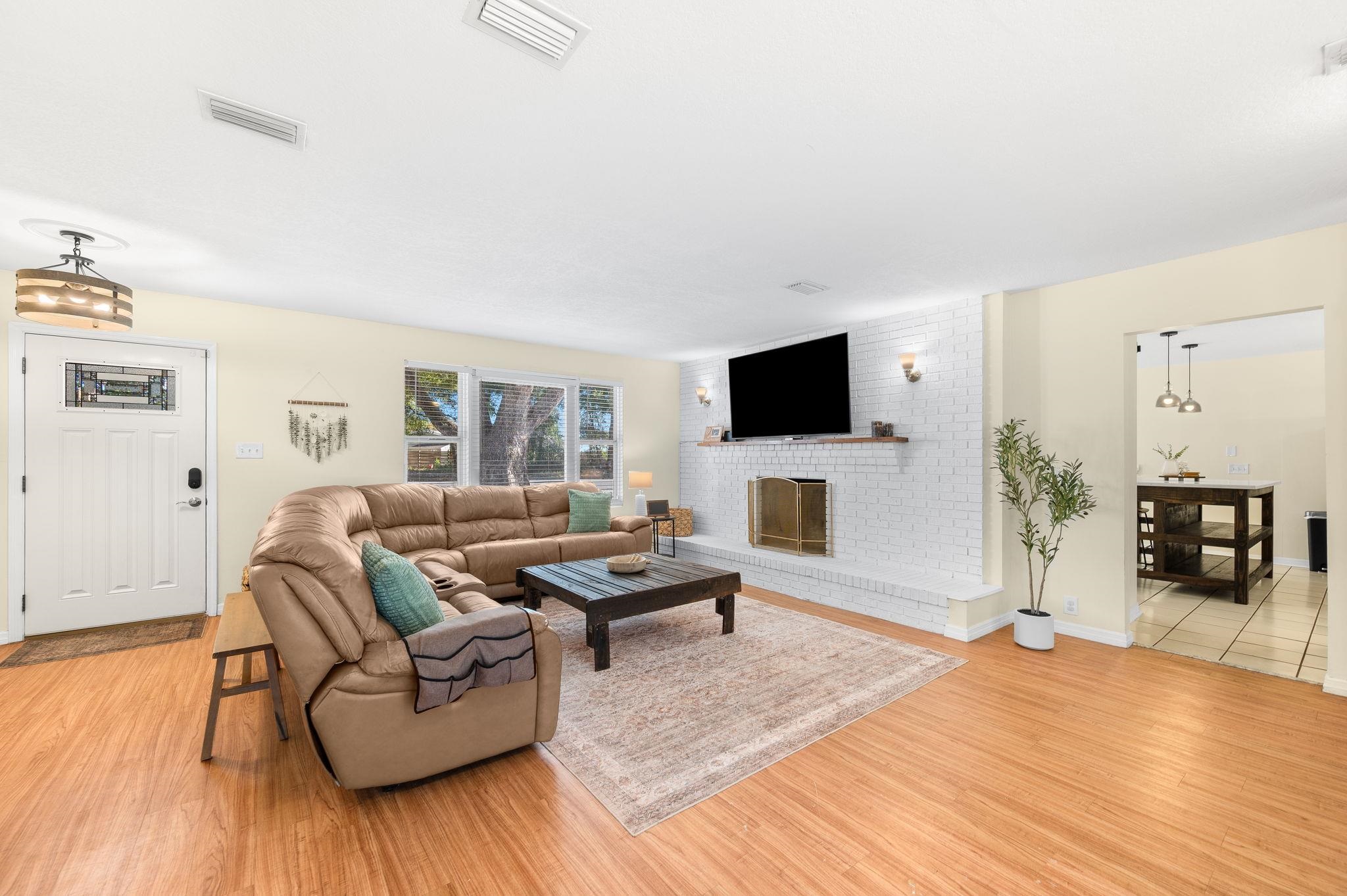 4233 Oak Lane St. Augustine, FL 32086 - Photo 11 of 42 Living room featuring light wood finished floors and a fireplace