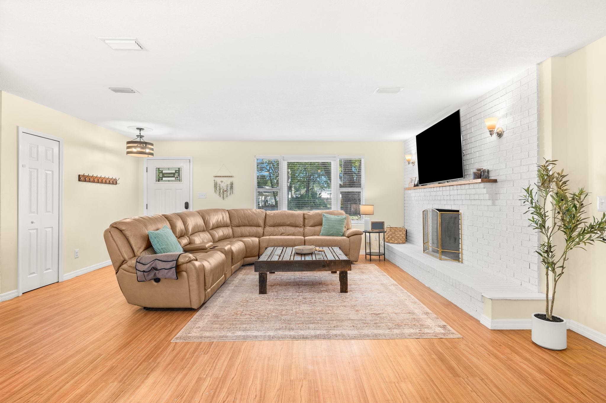 4233 Oak Lane St. Augustine, FL 32086 - Photo 12 of 42 Living area featuring light wood-style floors and a brick fireplace