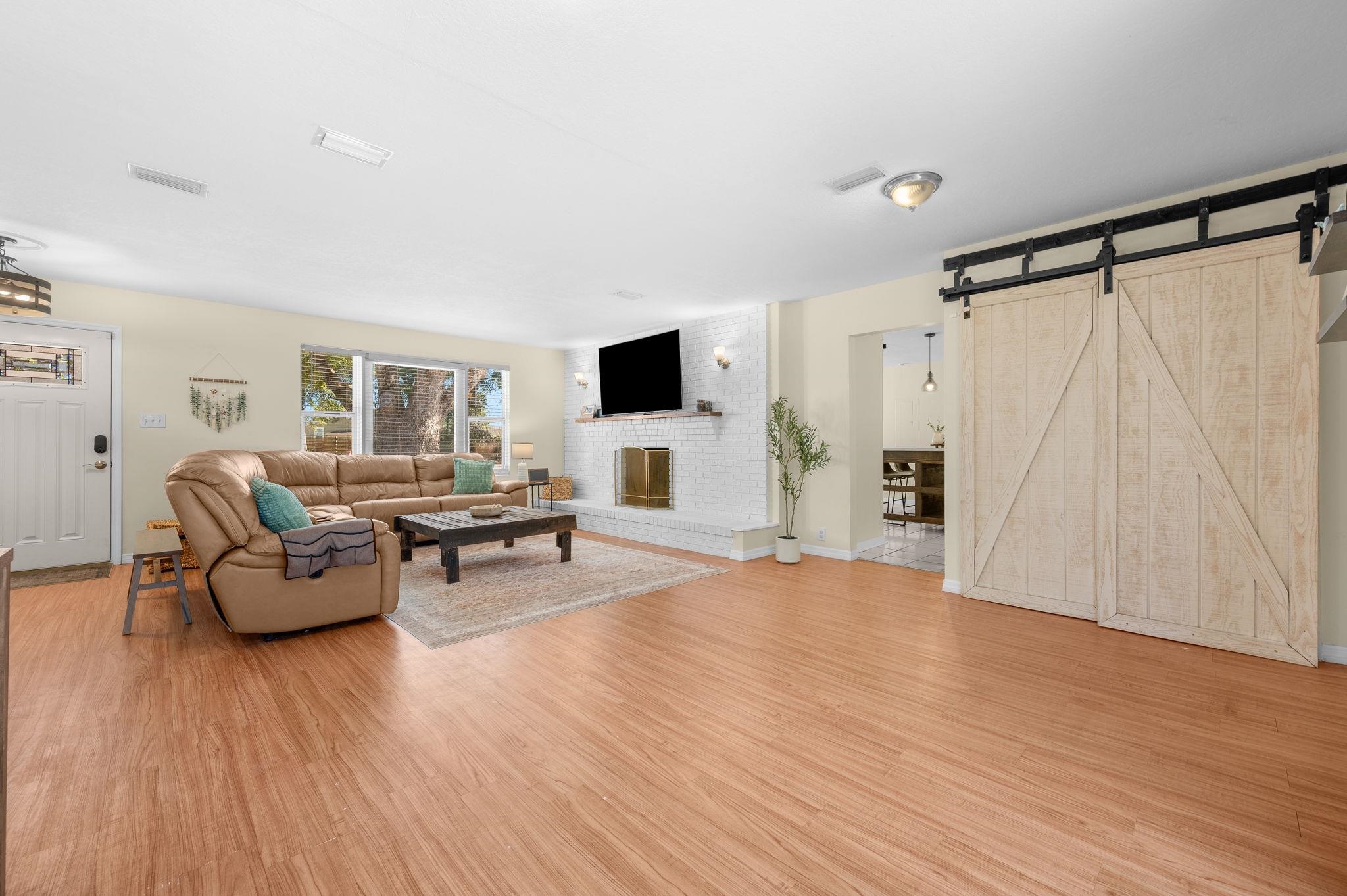 4233 Oak Lane St. Augustine, FL 32086 - Photo 18 of 42 Living area featuring light wood finished floors and a barn door
