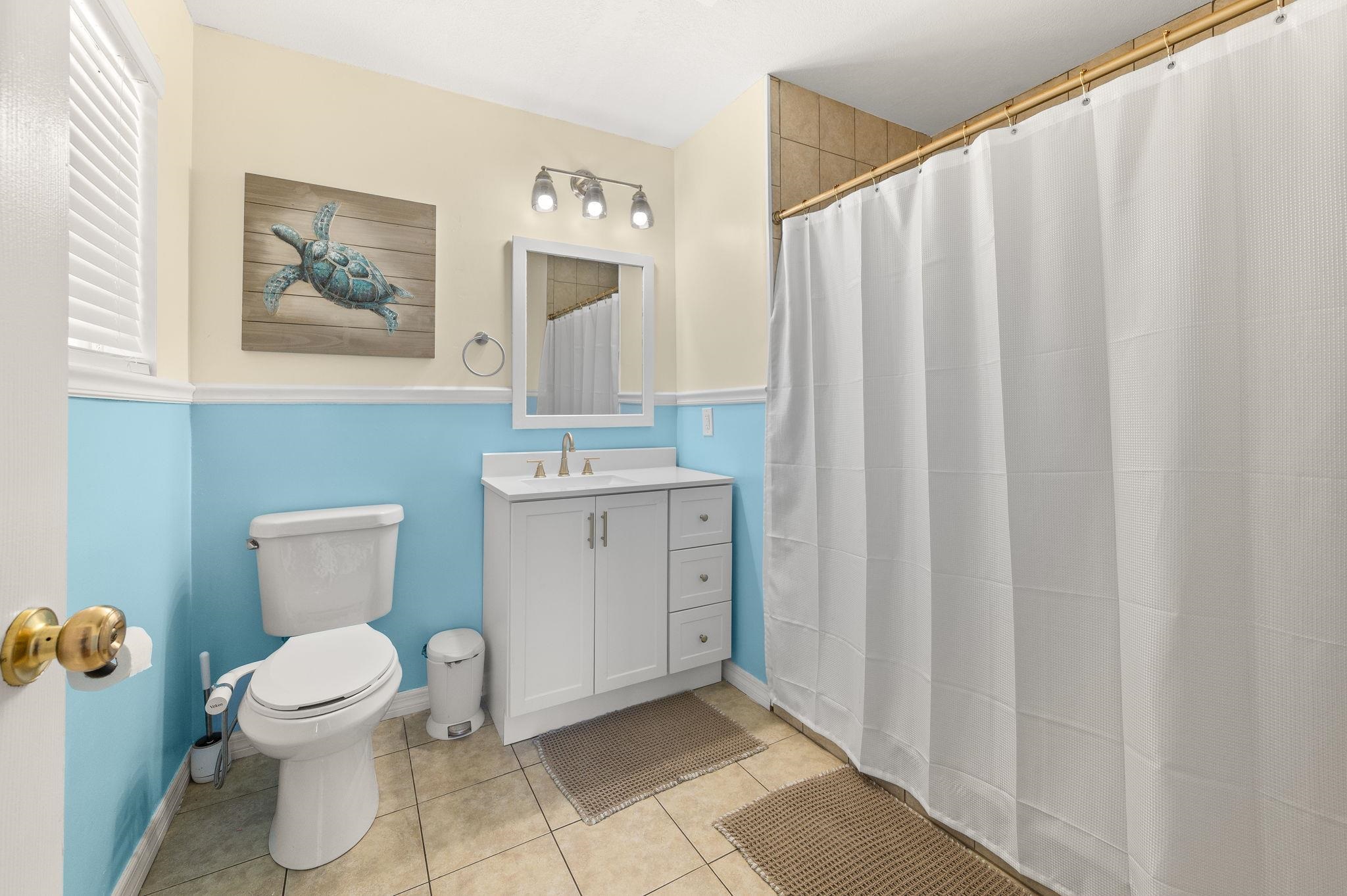 4233 Oak Lane St. Augustine, FL 32086 - Photo 33 of 42 Full bath with vanity, a shower with shower curtain, and light tile patterned floors