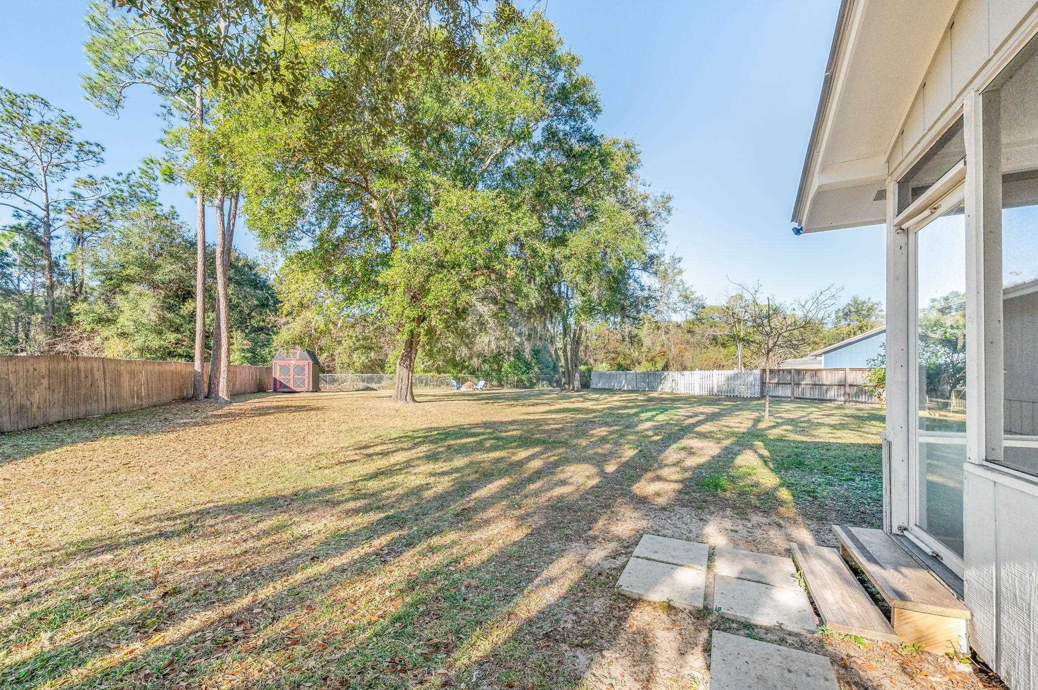 4233 Oak Lane St. Augustine, FL 32086 - Photo 39 of 42 Fenced backyard with a storage shed