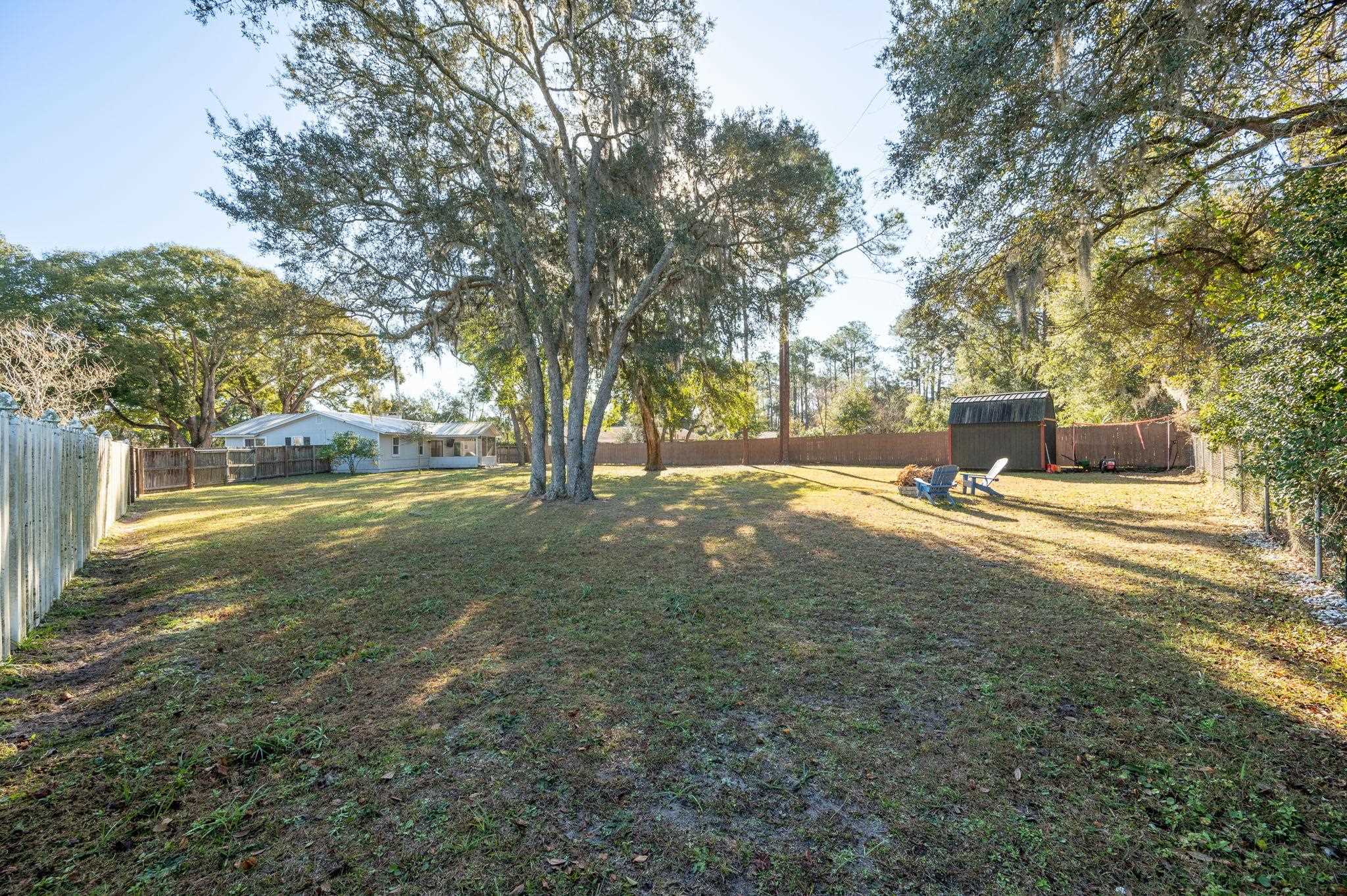 4233 Oak Lane St. Augustine, FL 32086 - Photo 41 of 42 Fenced backyard featuring a shed