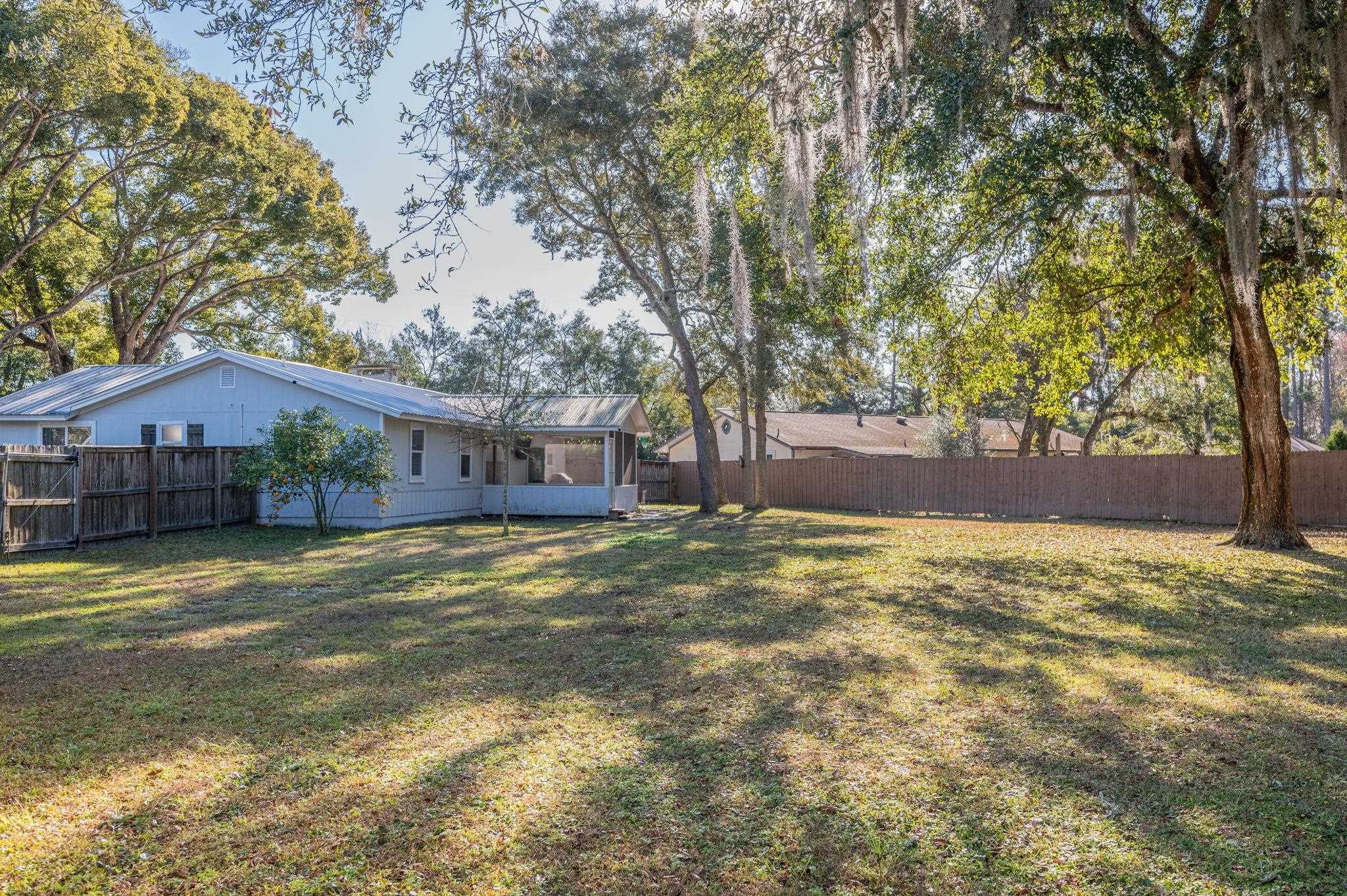 4233 Oak Lane St. Augustine, FL 32086 - Photo 42 of 42 Fenced backyard with a sunroom