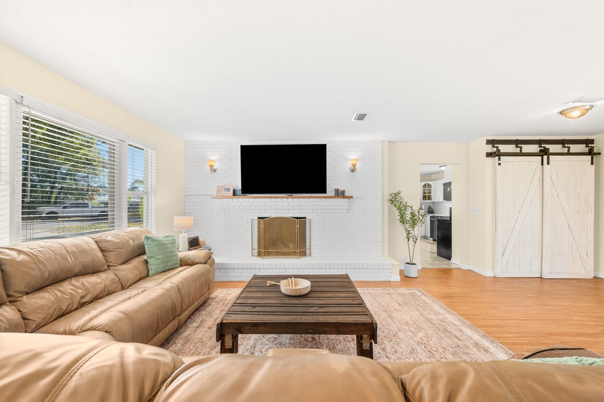 4233 Oak Lane St. Augustine, FL 32086 - Photo 10 of 42 Living area with a barn door and wood finished floors