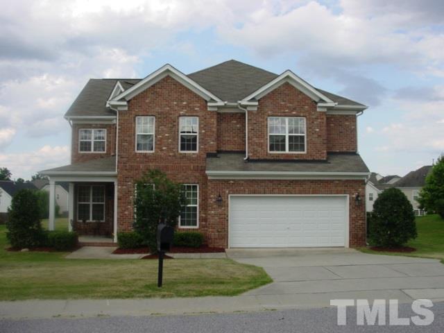 5212 Holly Ridge Farm Road Raleigh, NC 27616 - Photo 1 of 3 a front view of a house with a yard and garage