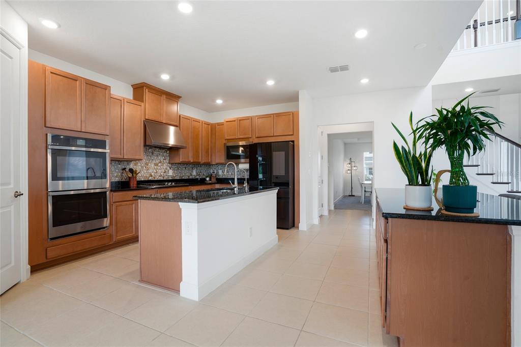 34068 Castaway Loop Wesley Chapel, FL 33543 - Photo 14 of 65 a kitchen with counter top space and appliances