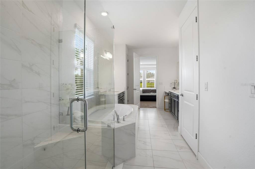 34068 Castaway Loop Wesley Chapel, FL 33543 - Photo 26 of 65 a kitchen with stainless steel appliances kitchen island granite countertop a refrigerator and a sink