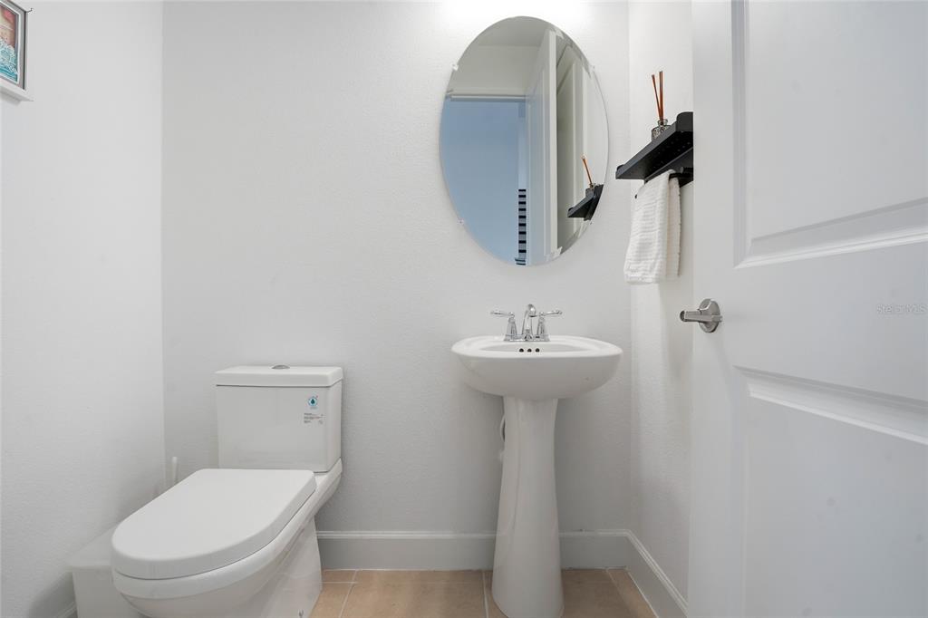 34068 Castaway Loop Wesley Chapel, FL 33543 - Photo 27 of 65 a bathroom with a toilet sink and mirror