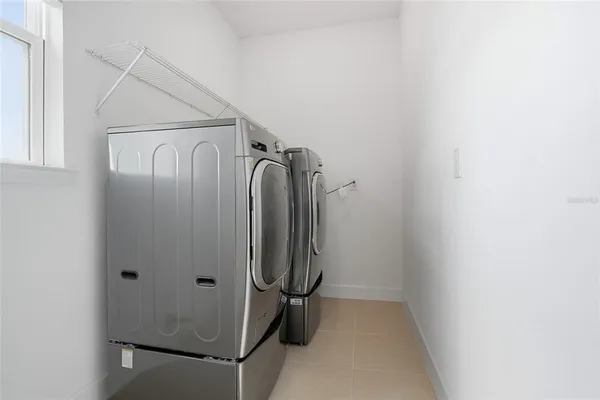 a bedroom with a bed and windows