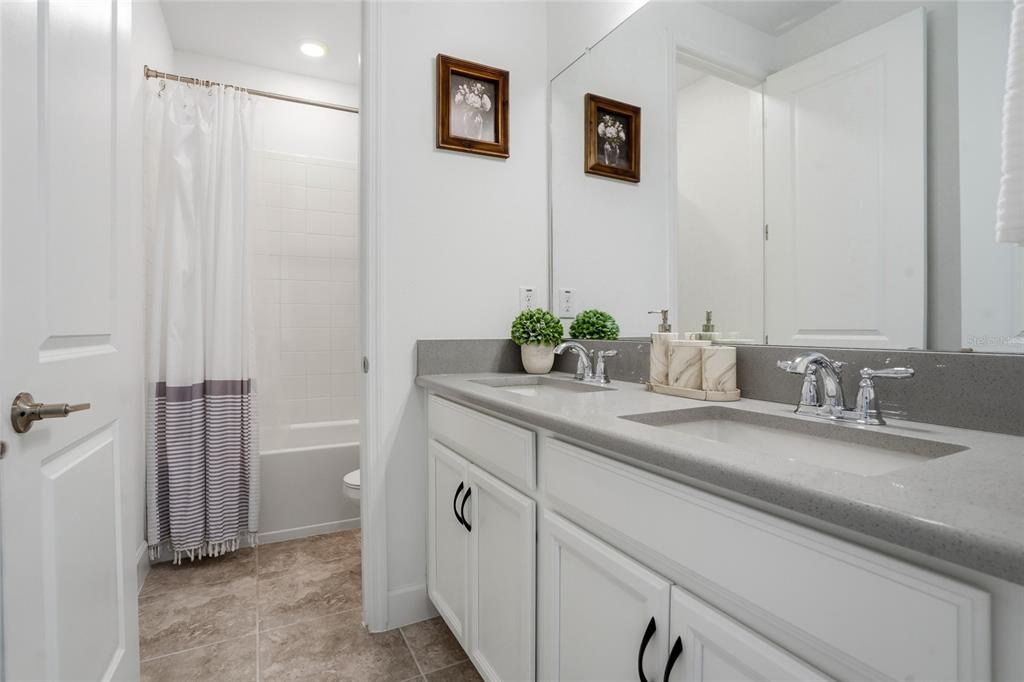 34068 Castaway Loop Wesley Chapel, FL 33543 - Photo 33 of 65 a bathroom with a granite countertop sink and a mirror