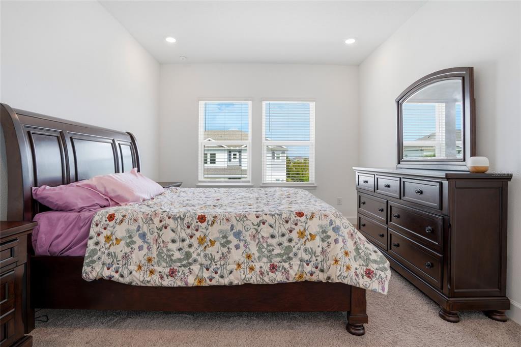 34068 Castaway Loop Wesley Chapel, FL 33543 - Photo 35 of 65 a bedroom with a bed and windows