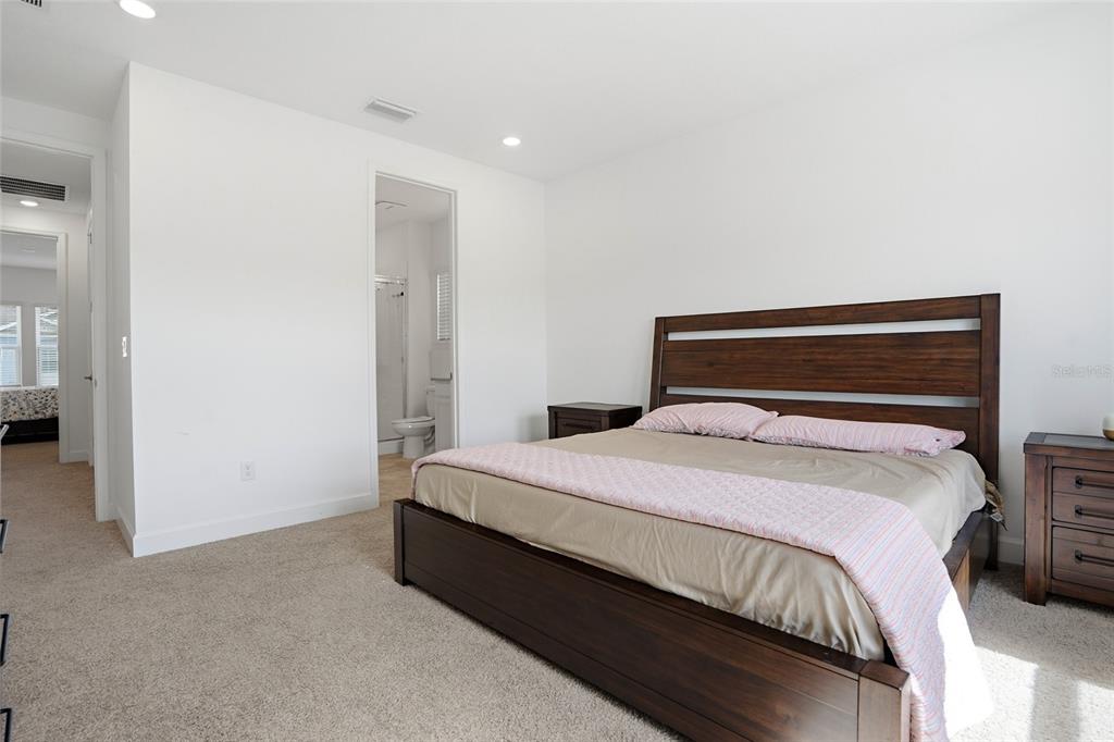 34068 Castaway Loop Wesley Chapel, FL 33543 - Photo 37 of 65 a bedroom with a bed and a mirror