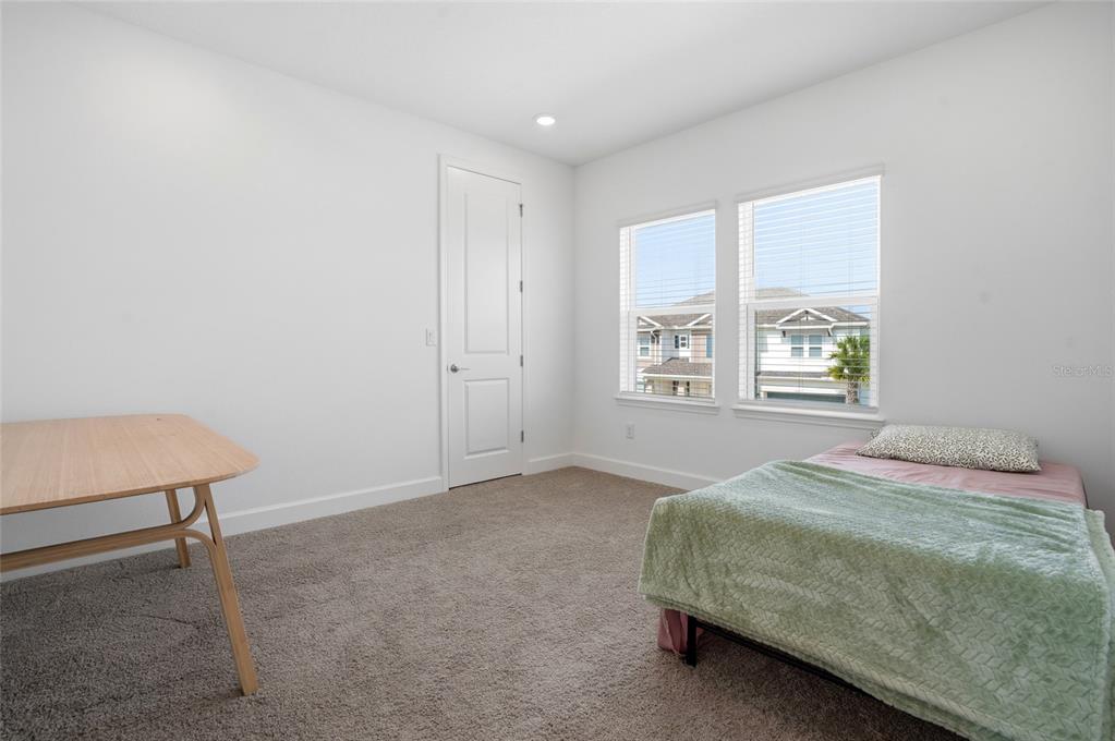 34068 Castaway Loop Wesley Chapel, FL 33543 - Photo 39 of 65 a bedroom with a bed and a window