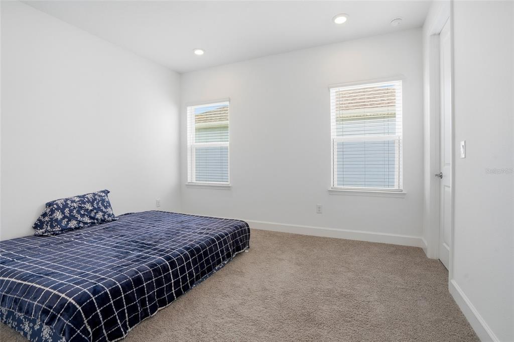 34068 Castaway Loop Wesley Chapel, FL 33543 - Photo 40 of 65 a bedroom with a bed and a window