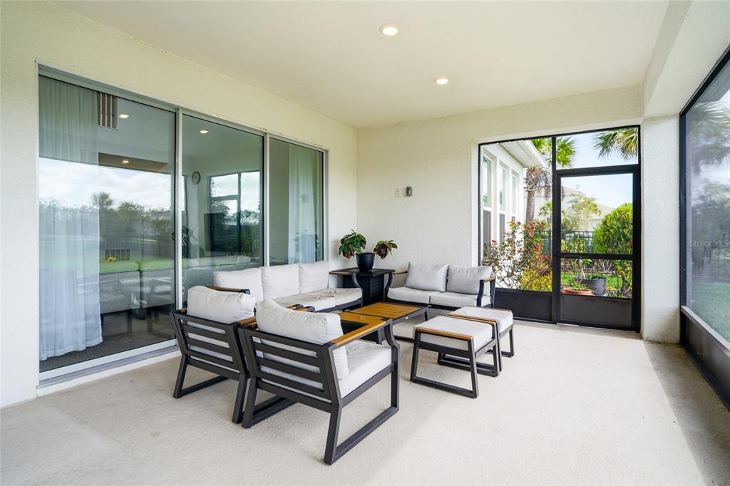 34068 Castaway Loop Wesley Chapel, FL 33543 - Photo 44 of 65 a living room with furniture and a large window