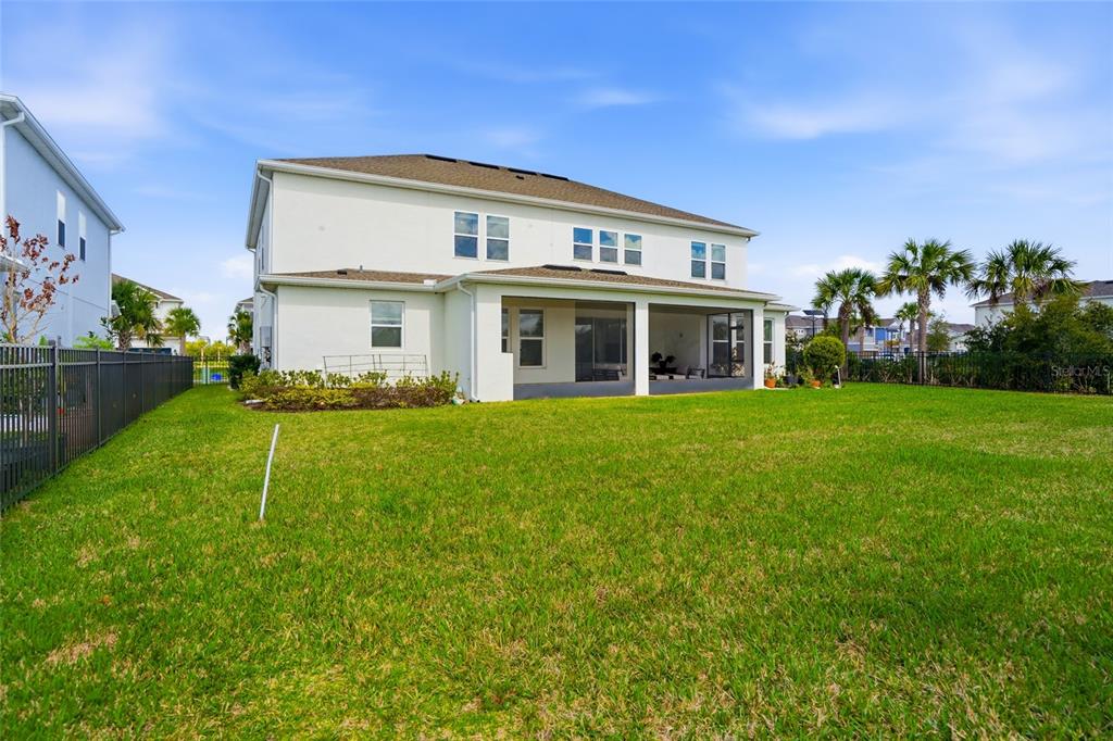 34068 Castaway Loop Wesley Chapel, FL 33543 - Photo 54 of 65 a view of a house with a yard