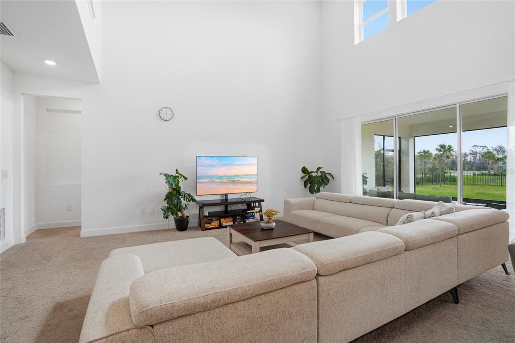 34068 Castaway Loop Wesley Chapel, FL 33543 - Photo 7 of 65 a living room with furniture and a large window