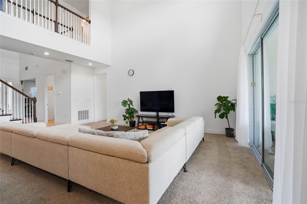 34068 Castaway Loop Wesley Chapel, FL 33543 - Photo 8 of 65 a living room with furniture and a flat screen tv