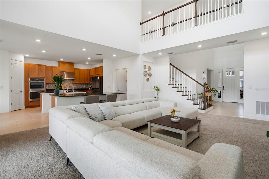 34068 Castaway Loop Wesley Chapel, FL 33543 - Photo 9 of 65 a living room with furniture and kitchen view