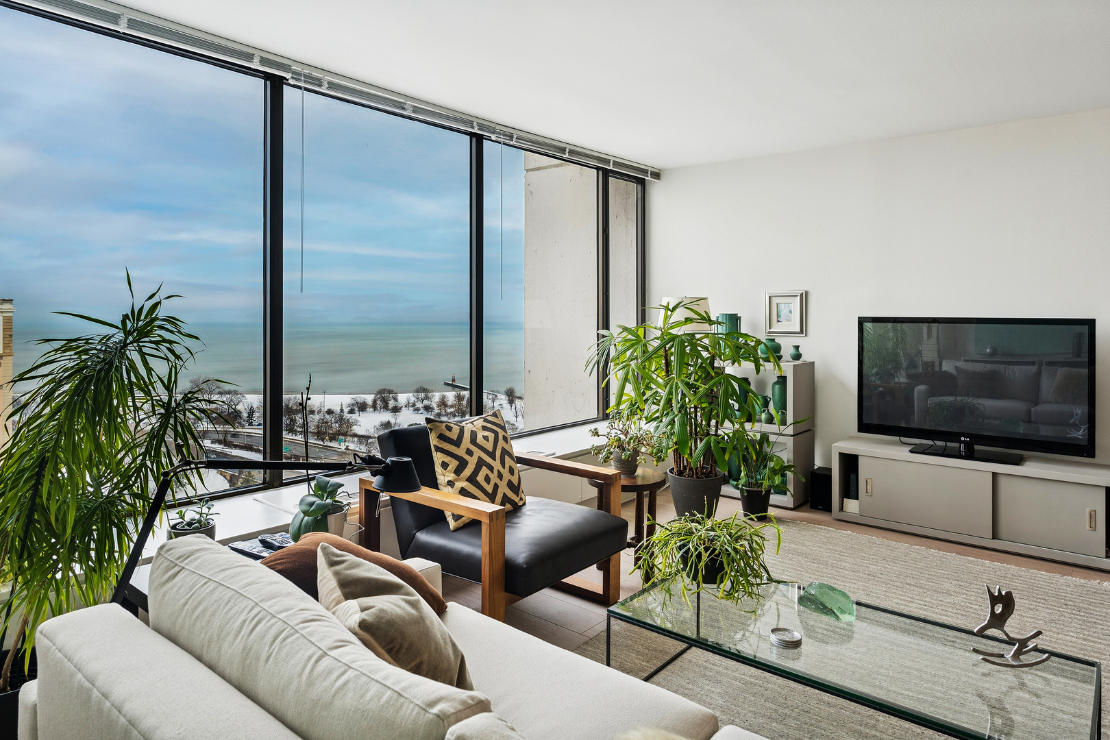 5455 North Sheridan Road, Unit 2403 Chicago, IL 60640 - Photo 5 of 20 a living room with furniture and a flat screen tv